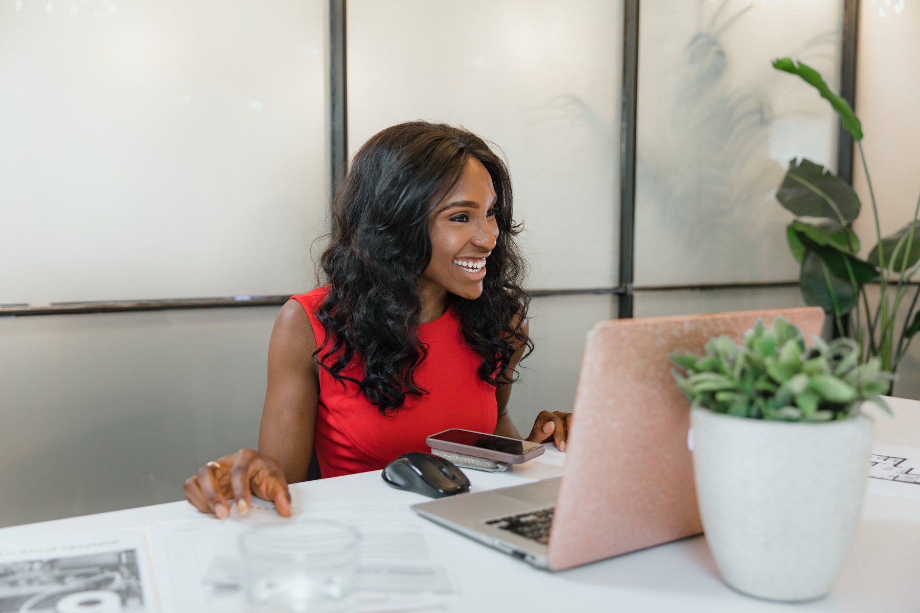 Black business owner working at a laptop in a modern office