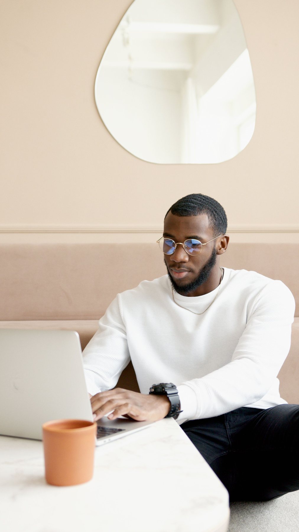 Black professional working on a laptop